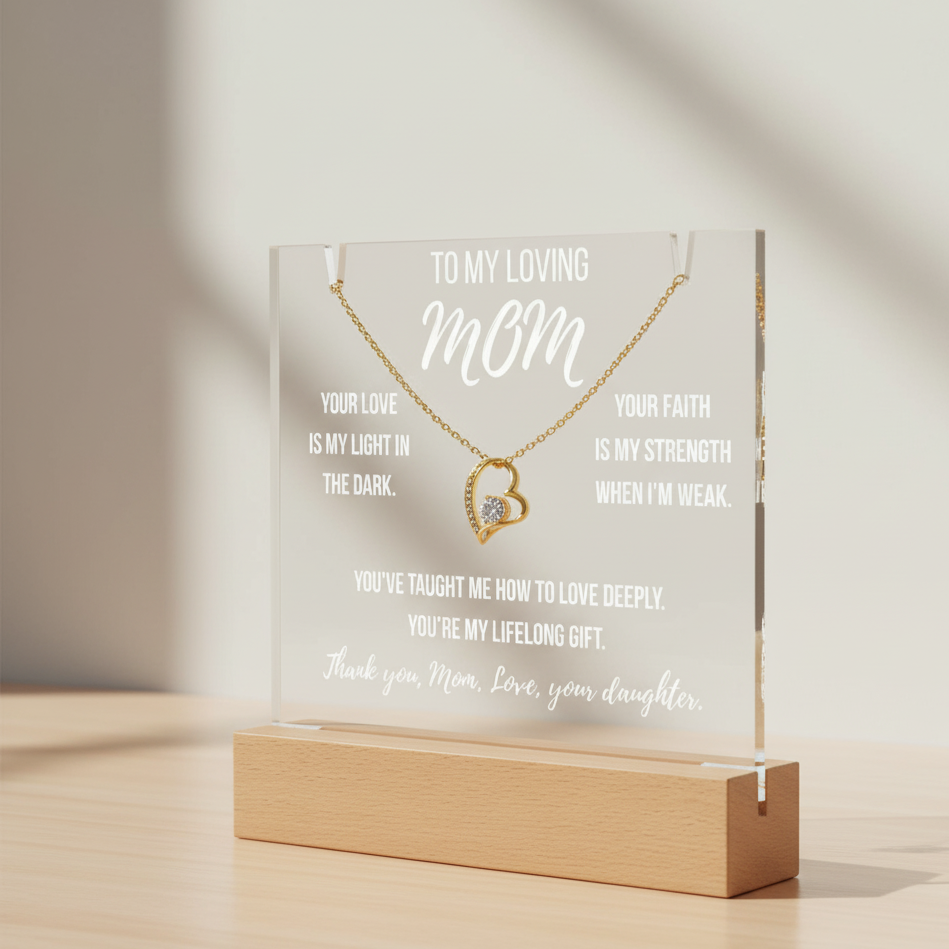 Necklace in a clear display case with engraved message on a wooden stand