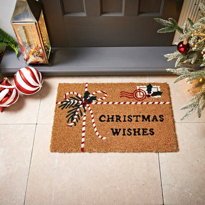 Coir holiday doormat featuring holly, a festive ribbon, and warm Christmas greetings.
